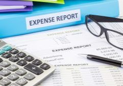 Detailed expense report with calculator, pen, and eyeglasses on financial documents, illustrating accounting, bookkeeping, and tax services offered by GMS Accountants in the UK.