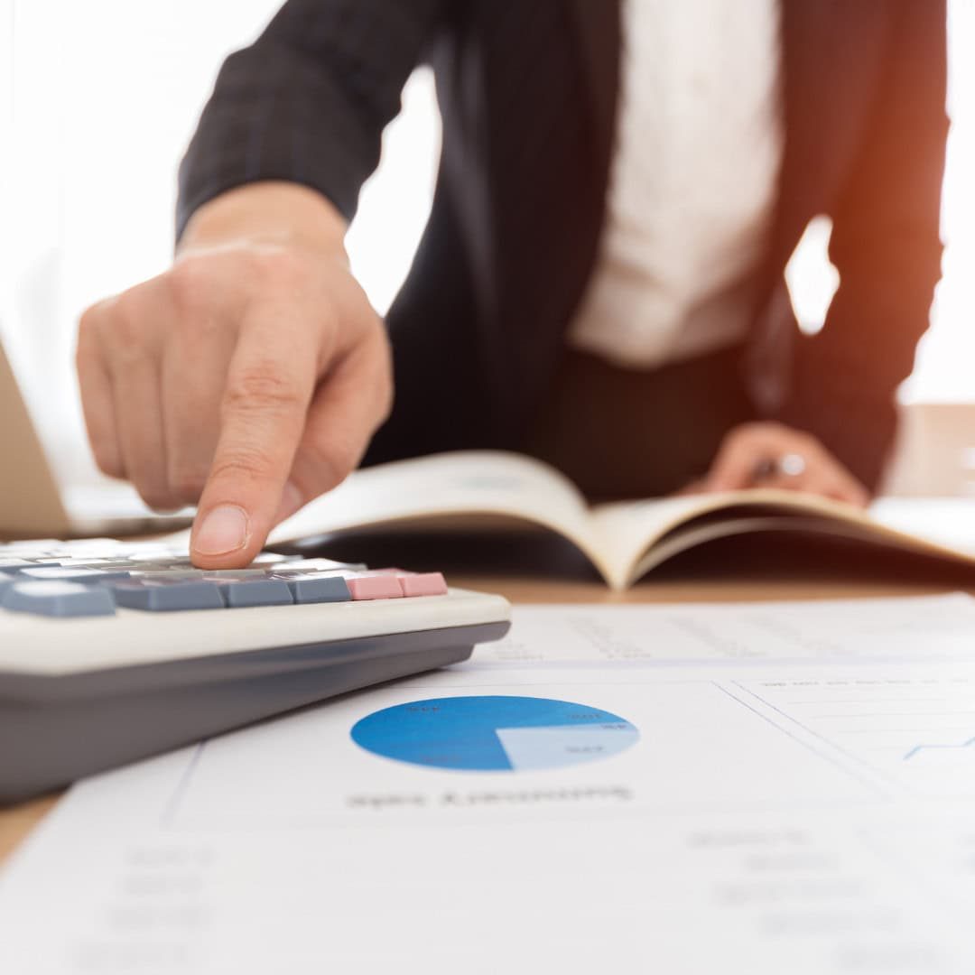 Calculator and financial documents for accounting and bookkeeping services at GMS Accountants.