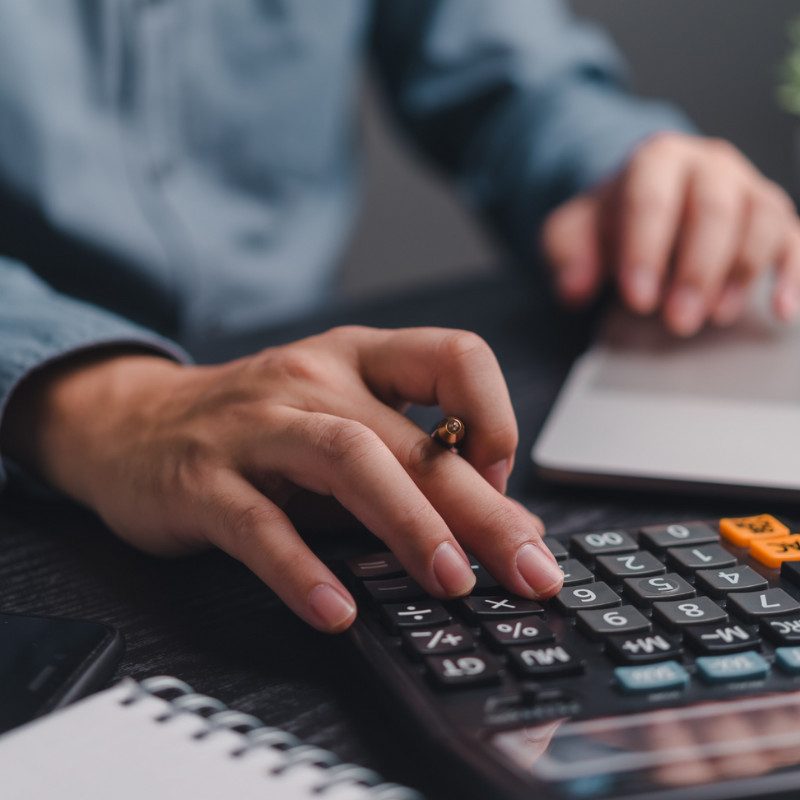 Accurate financial calculations being carried out by a professional accountant using a calculator, representing expert financial and accounting services in the UK.